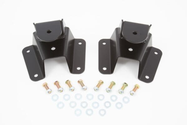 Two black engine mounts with bolts and washers.