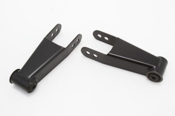 Two black metal suspension lift brackets.