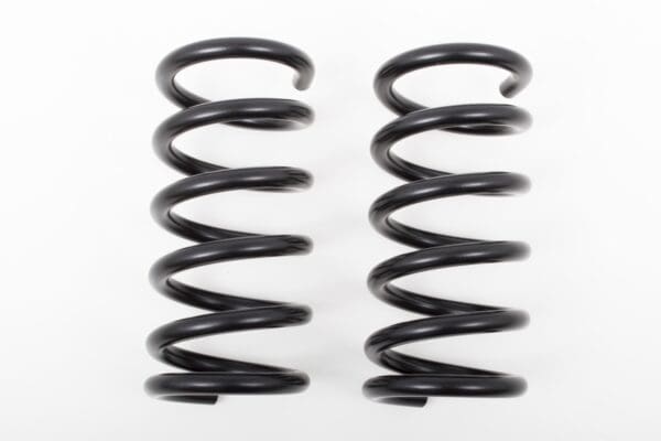 Two black coil springs isolated on white.