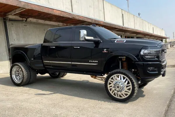 Black Ram 3500 pickup truck with chrome wheels.