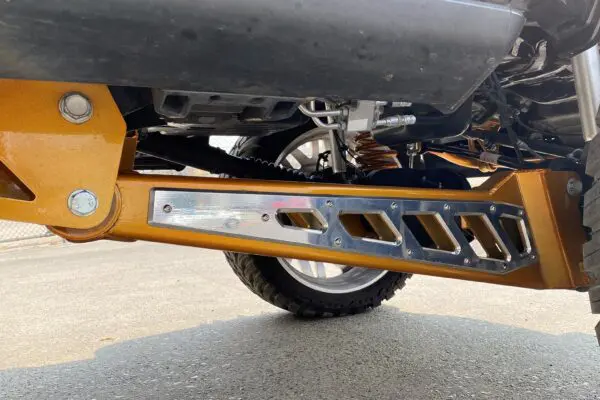 Gold truck suspension with chrome accents.