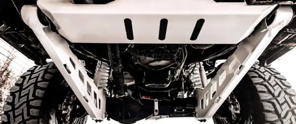 Underside of a lifted truck with off-road tires.