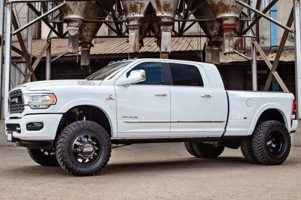 White Ram pickup truck with black rims.