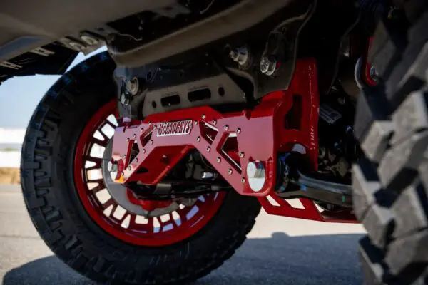 Red truck suspension with McCaughy's logo.