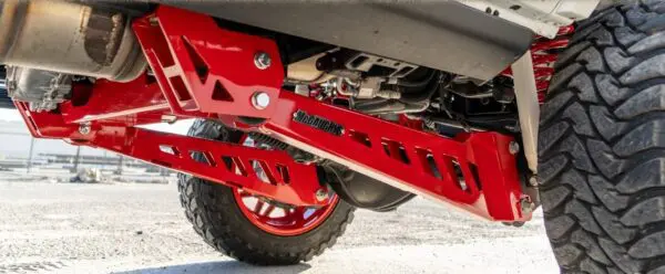 Red truck suspension with large tires.