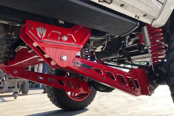 Red truck suspension with McGaughys logo.