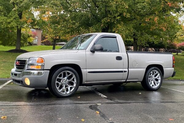 Silver GMC pickup truck with chrome wheels.