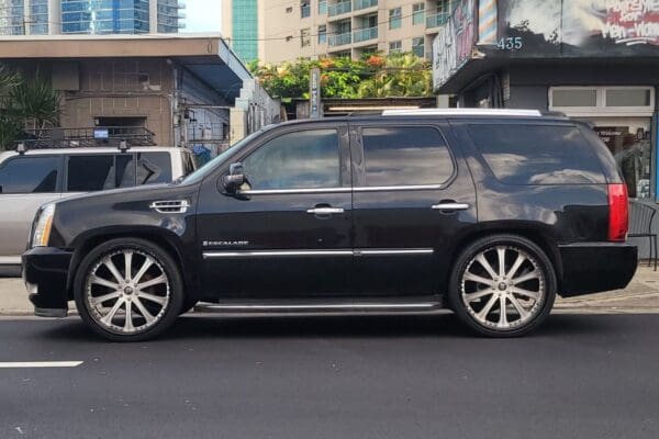 Black Cadillac Escalade parked on street.