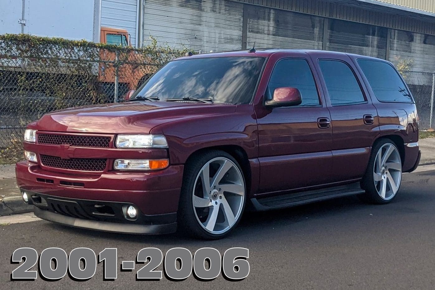 Red Chevrolet Tahoe with custom rims.