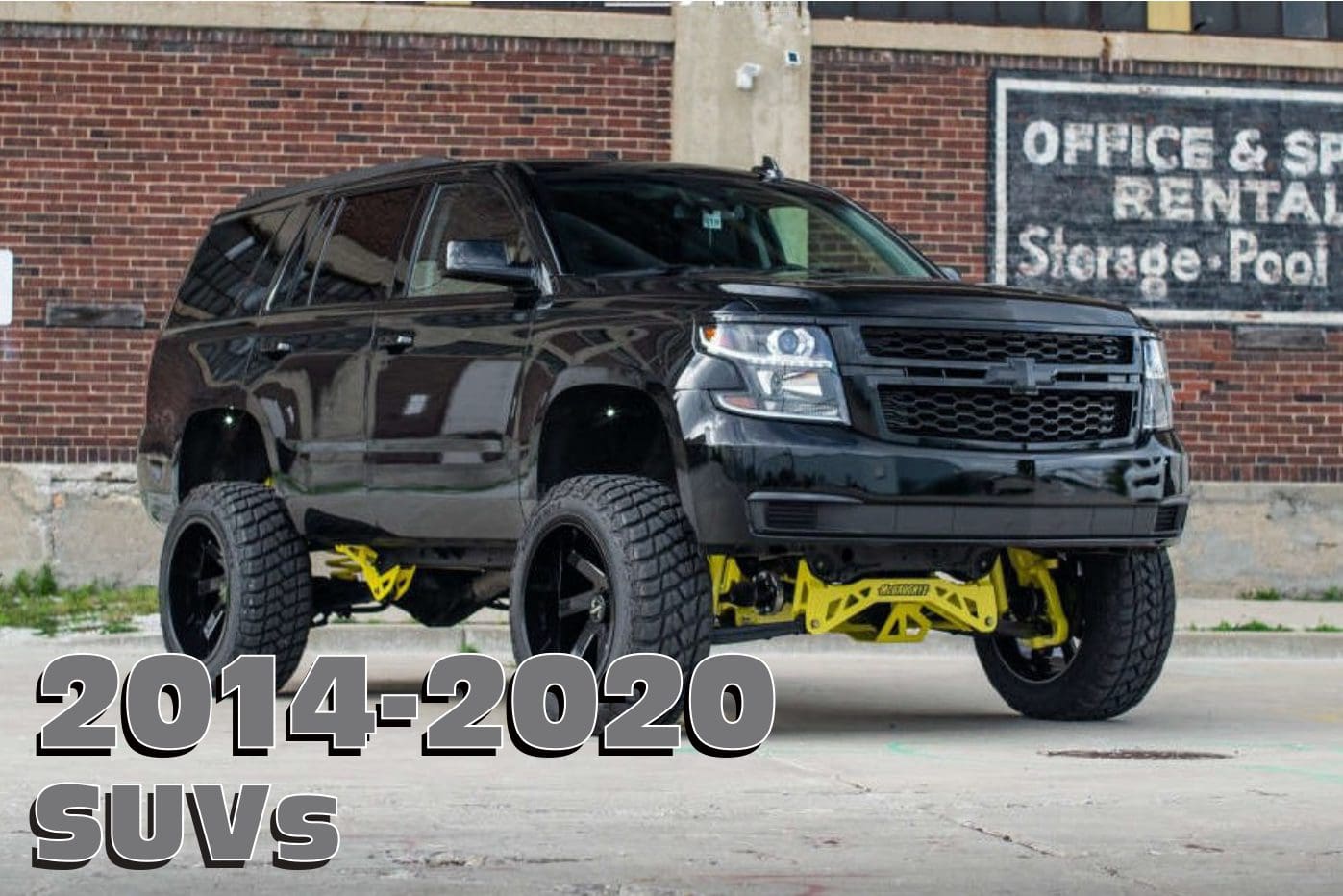 Black SUV with yellow suspension lift kit.