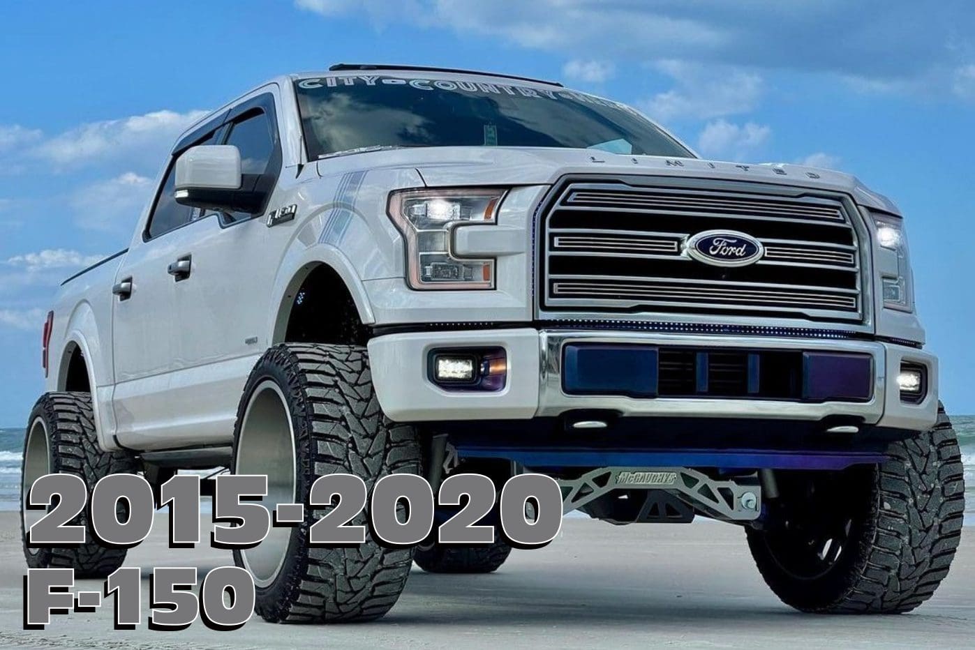 White Ford F-150 pickup truck on beach.