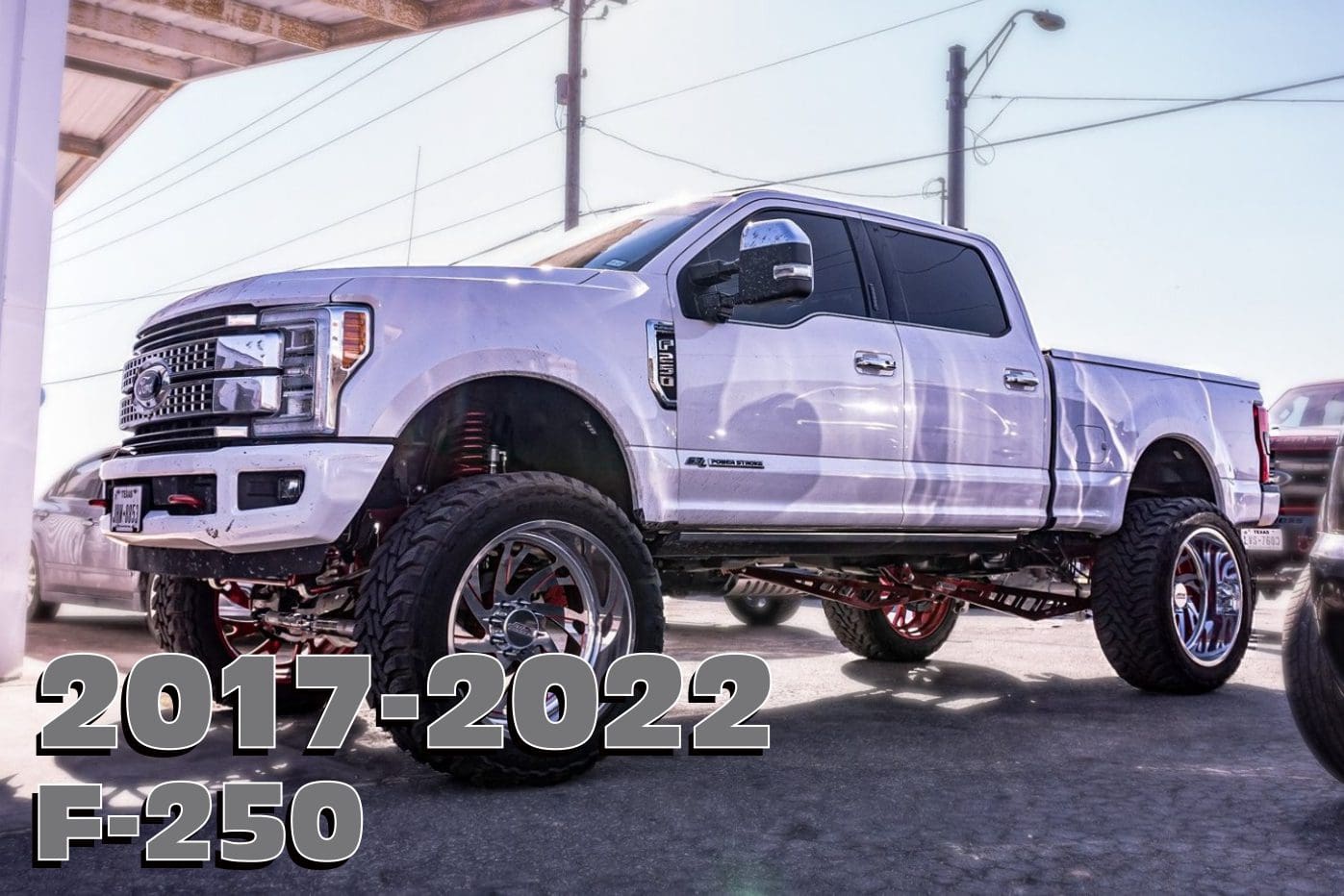 White Ford F-250 truck with large rims.