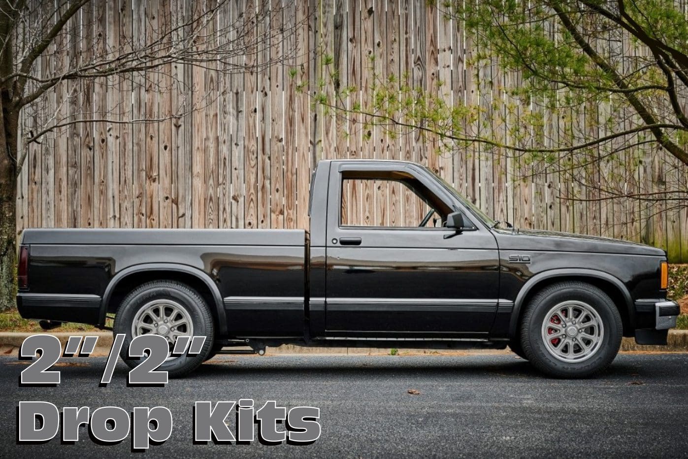 Black pickup truck with drop kits.