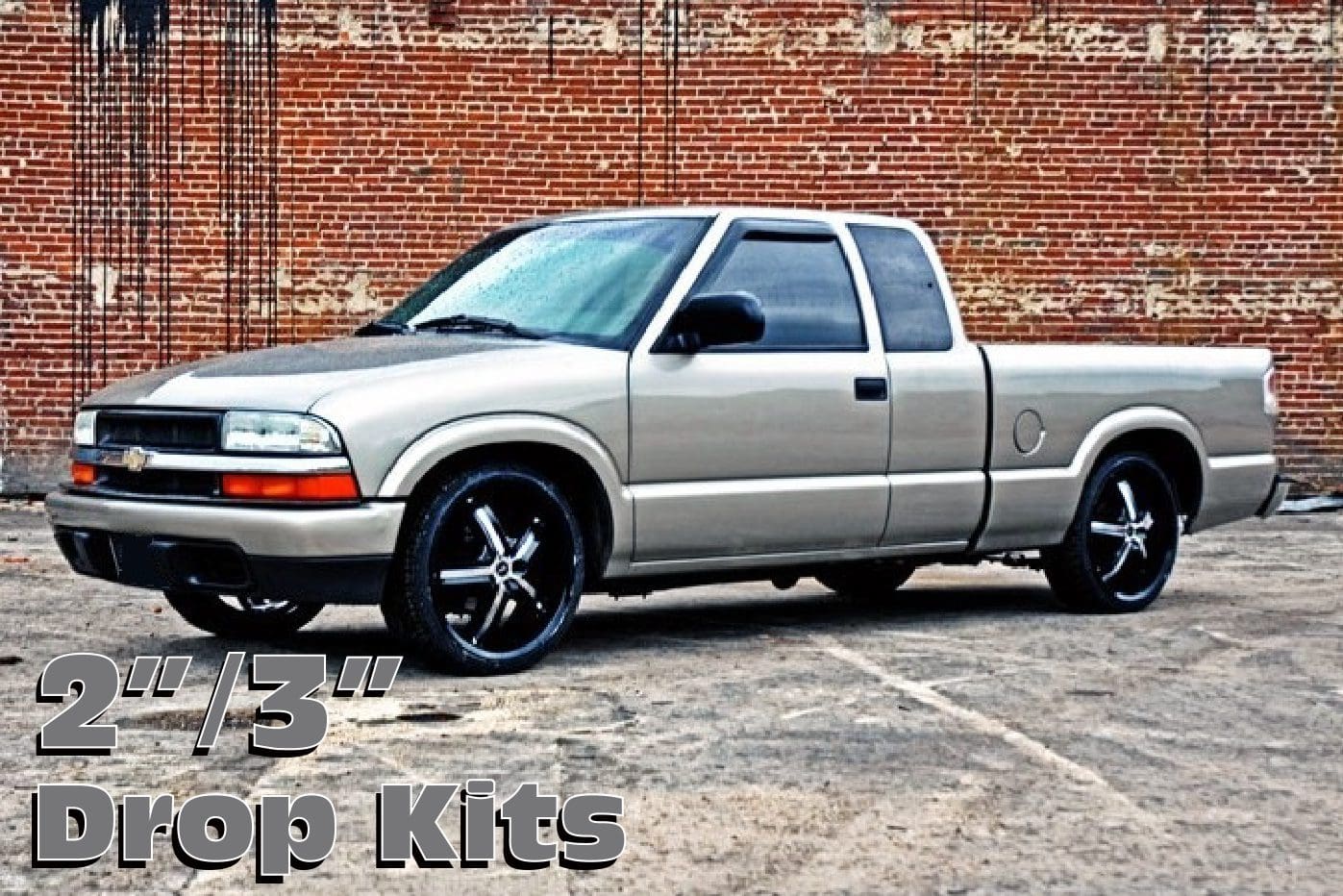 Silver pickup truck with drop kits.