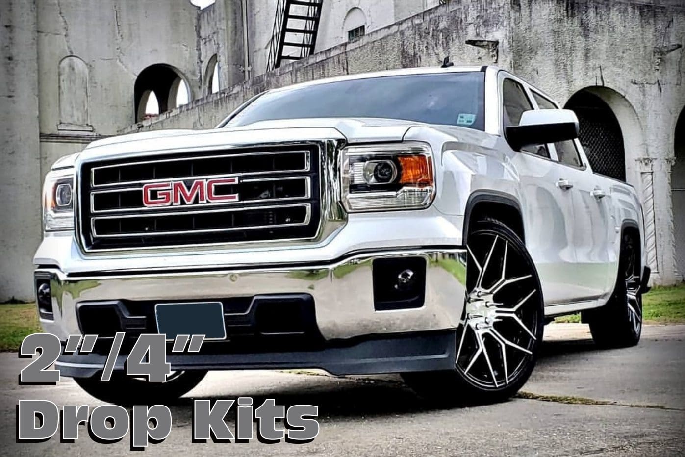 White GMC truck with drop kits.