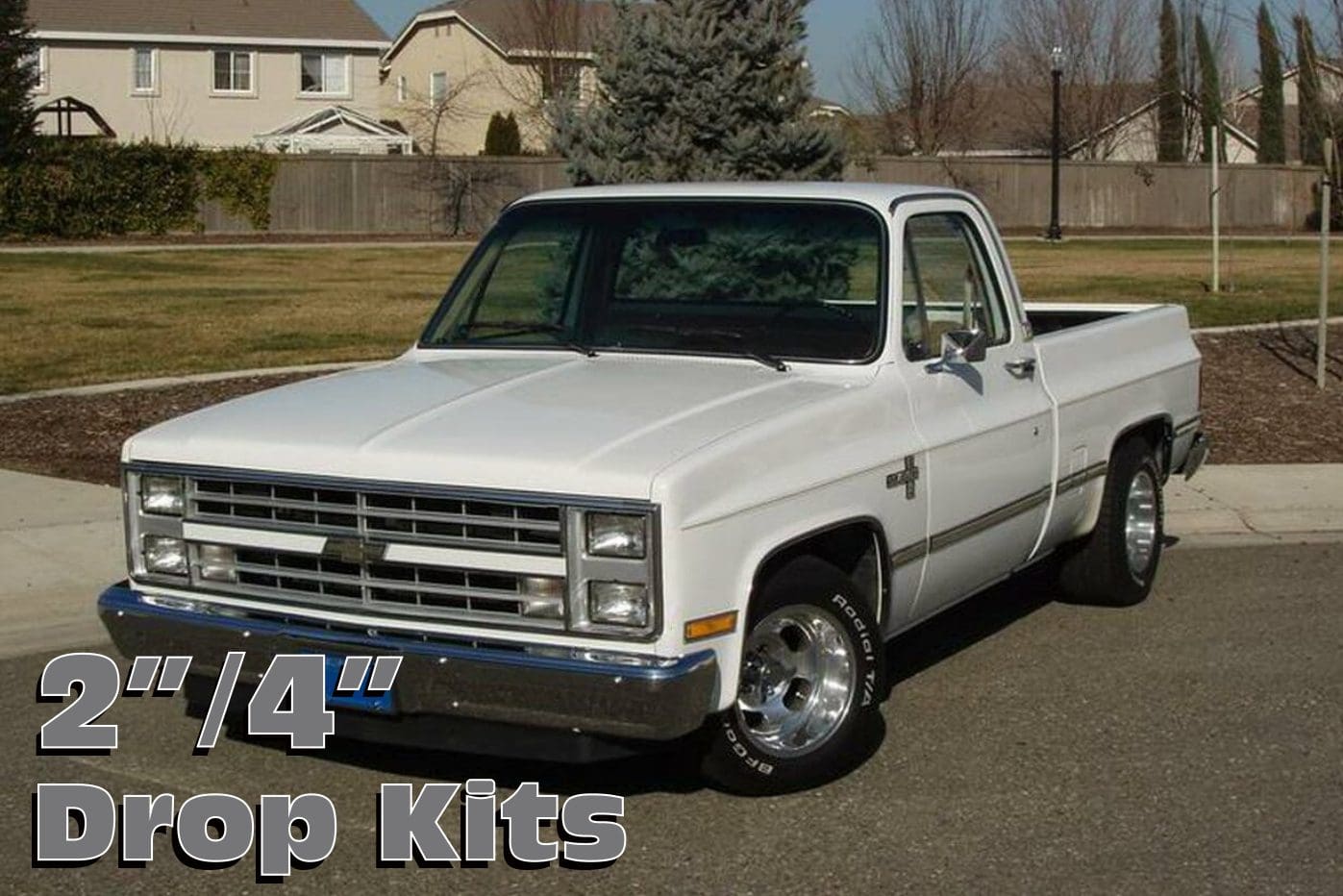 White Chevrolet pickup truck with drop kits.