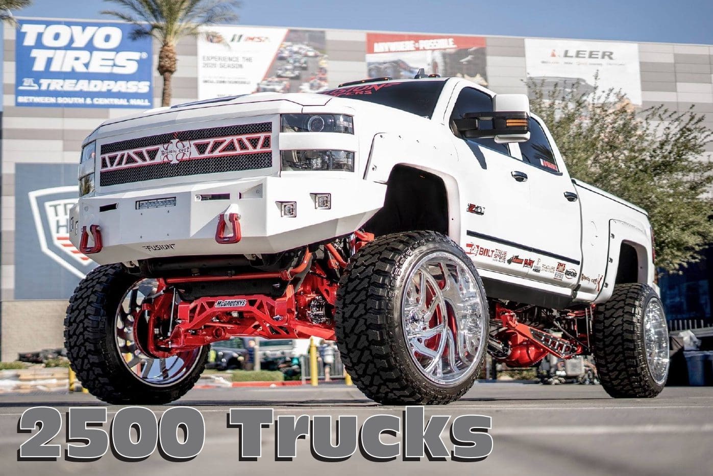 White lifted Chevrolet Silverado truck with red accents.