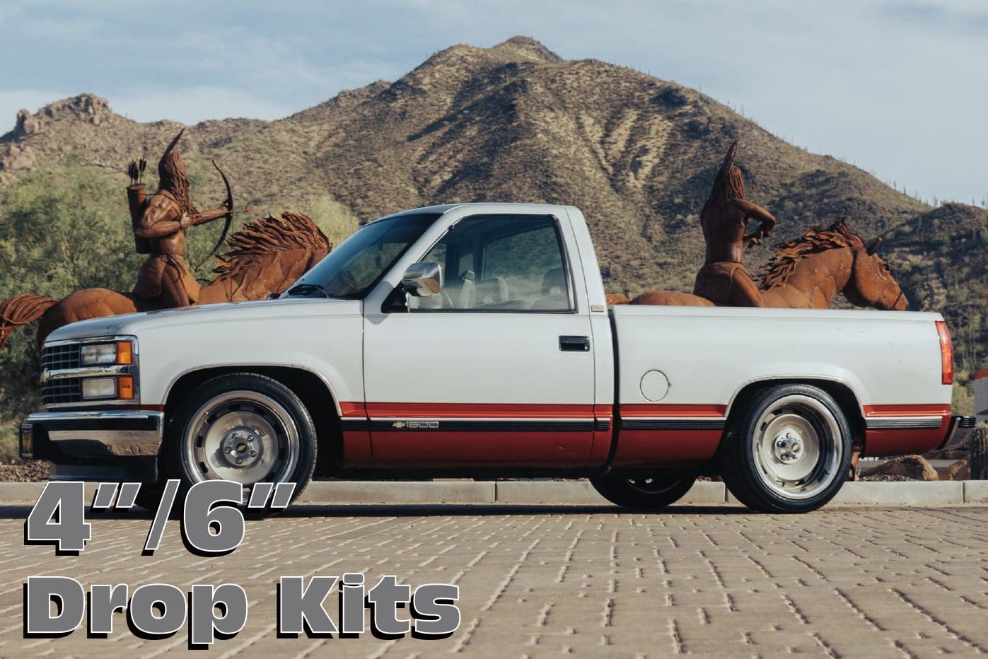 White pickup truck with drop kits.