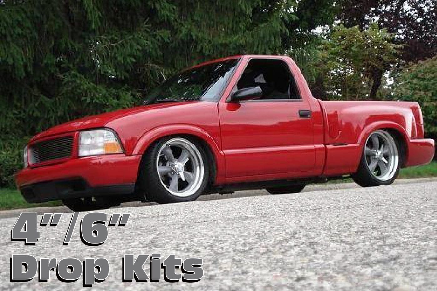 Red pickup truck with drop kit.