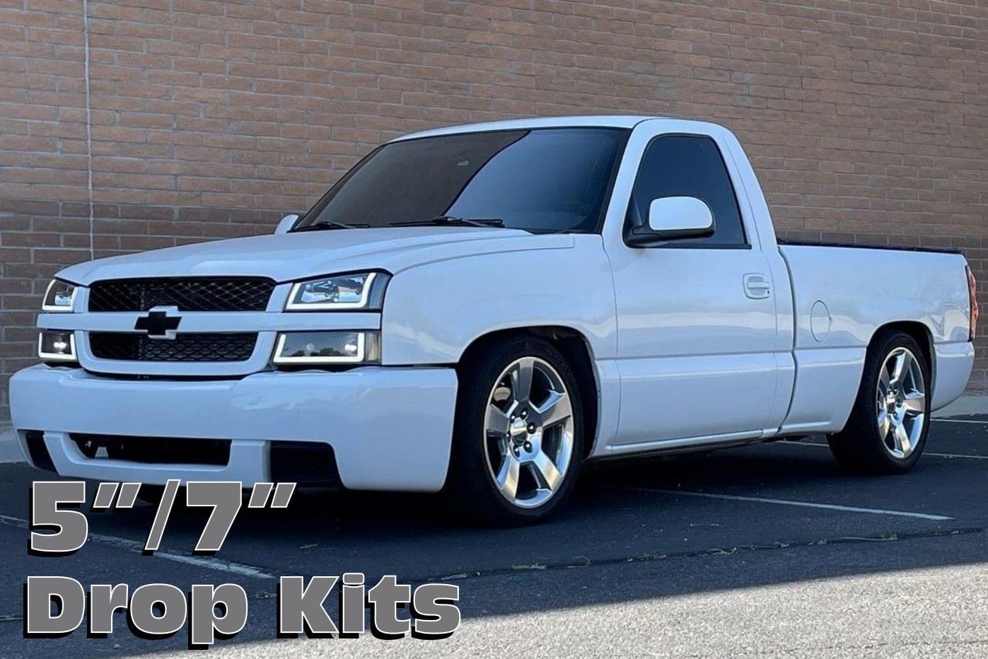 White Chevrolet Silverado with drop kits.