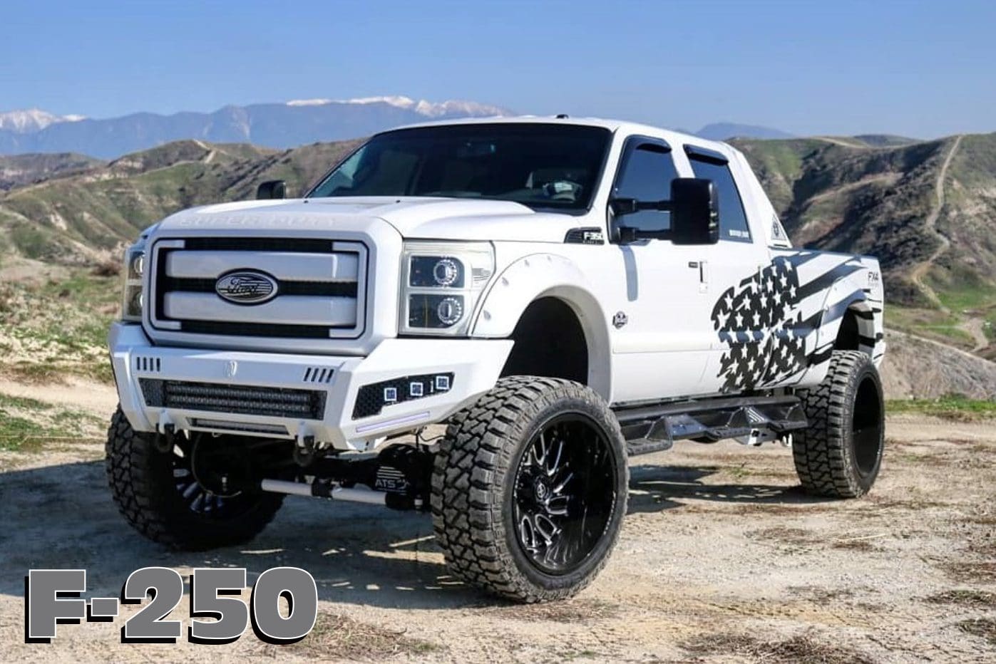 White Ford F-250 pickup truck with an American flag design.