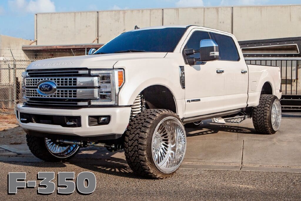 White Ford F-350 pickup truck with chrome wheels.