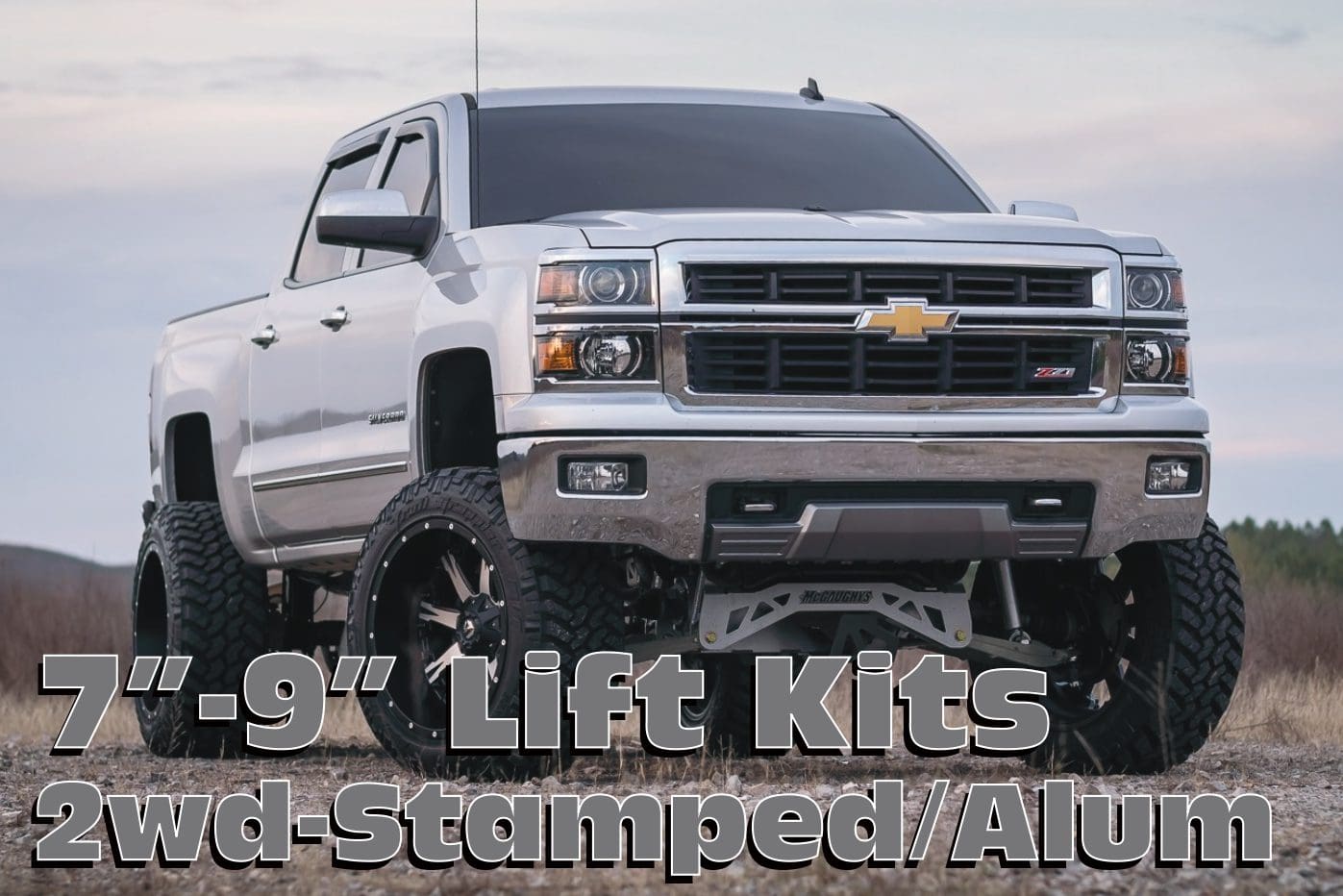 Silver Chevrolet Silverado with lift kit.