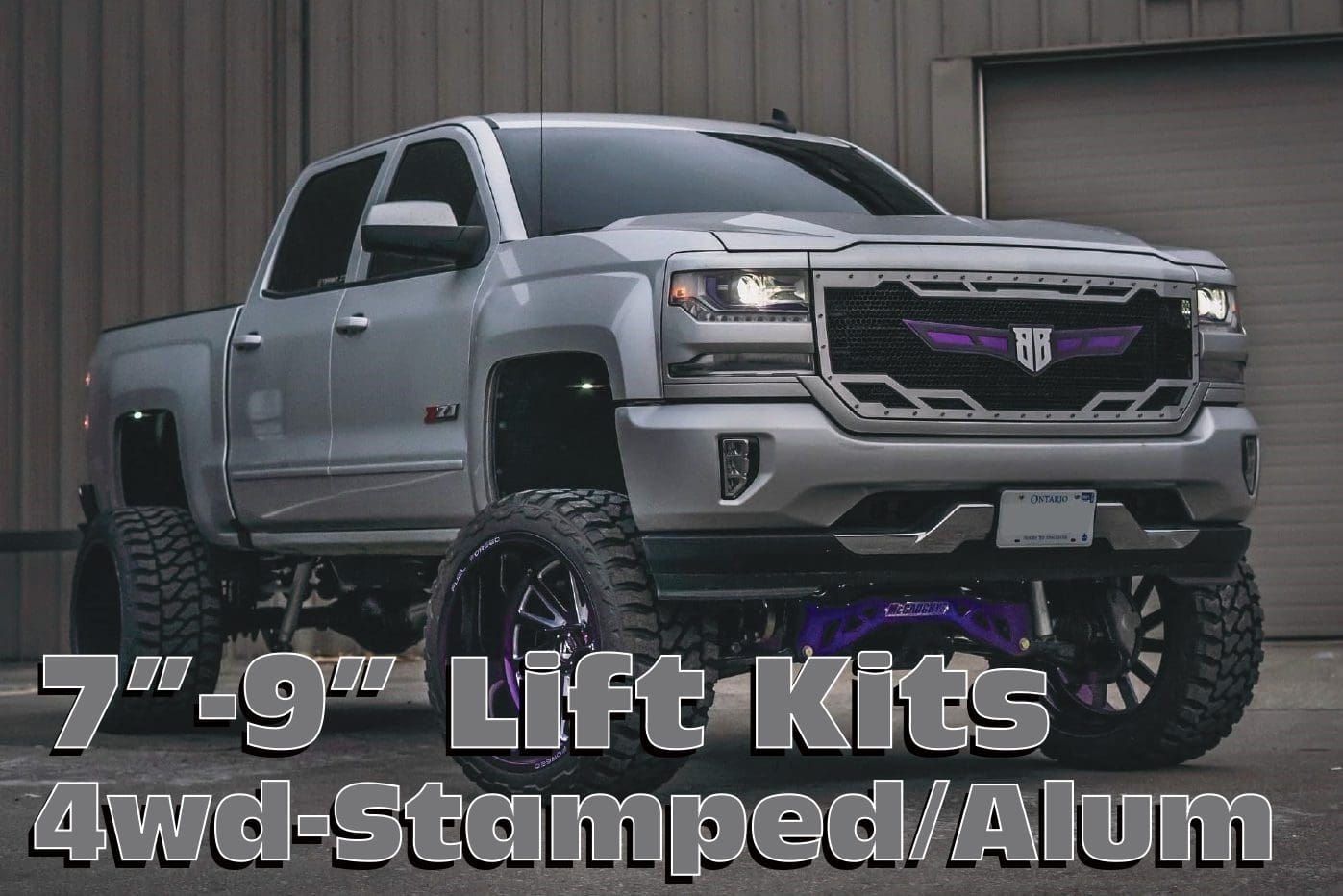 Silver pickup truck with lift kit.