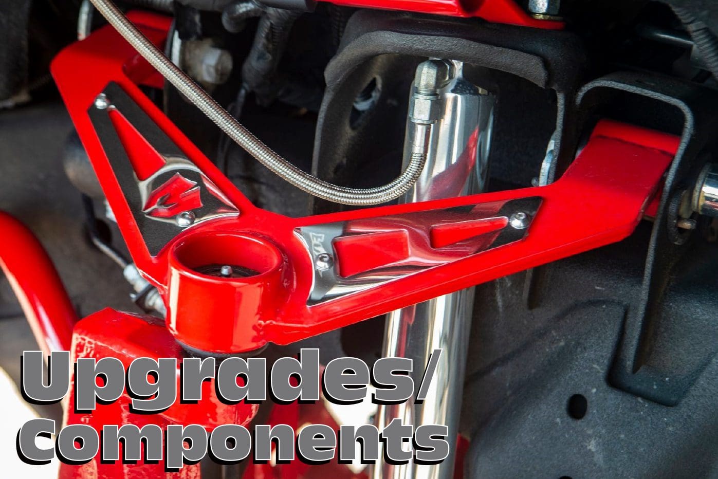 Red car suspension upgrade components.