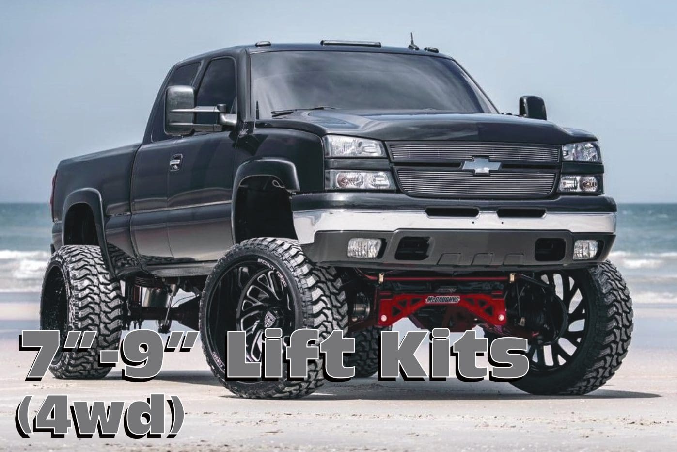 Black truck with lift kit on beach.