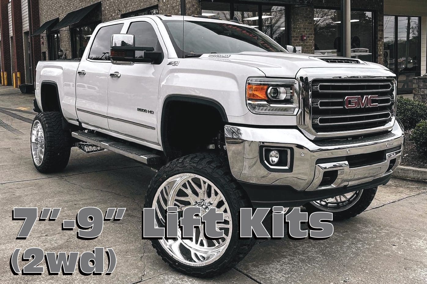 White GMC truck with lift kit.