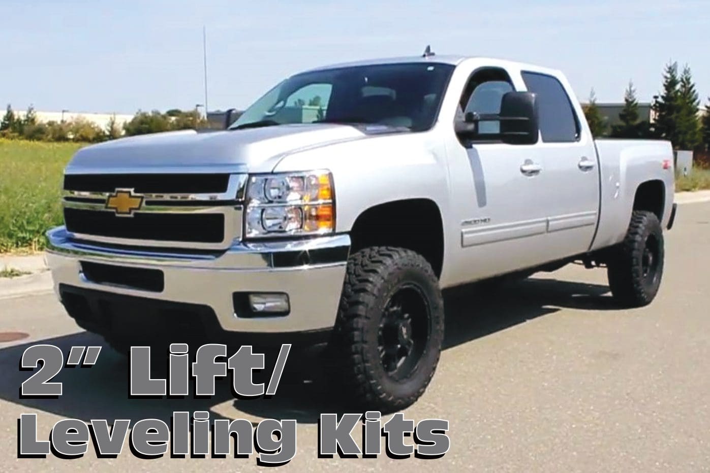 Silver Chevrolet pickup truck with lift kit.