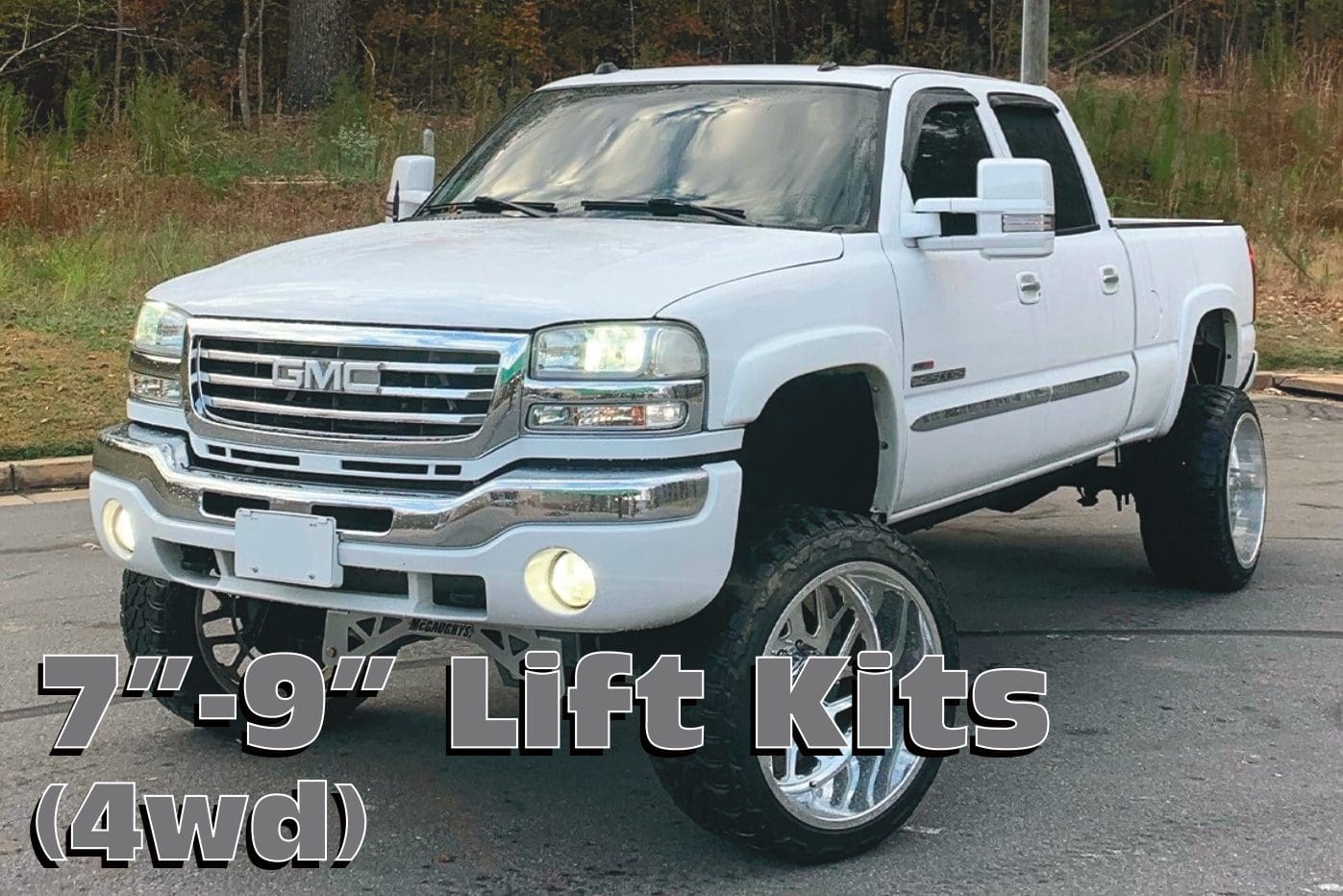 White GMC Sierra pickup truck with lift kit.