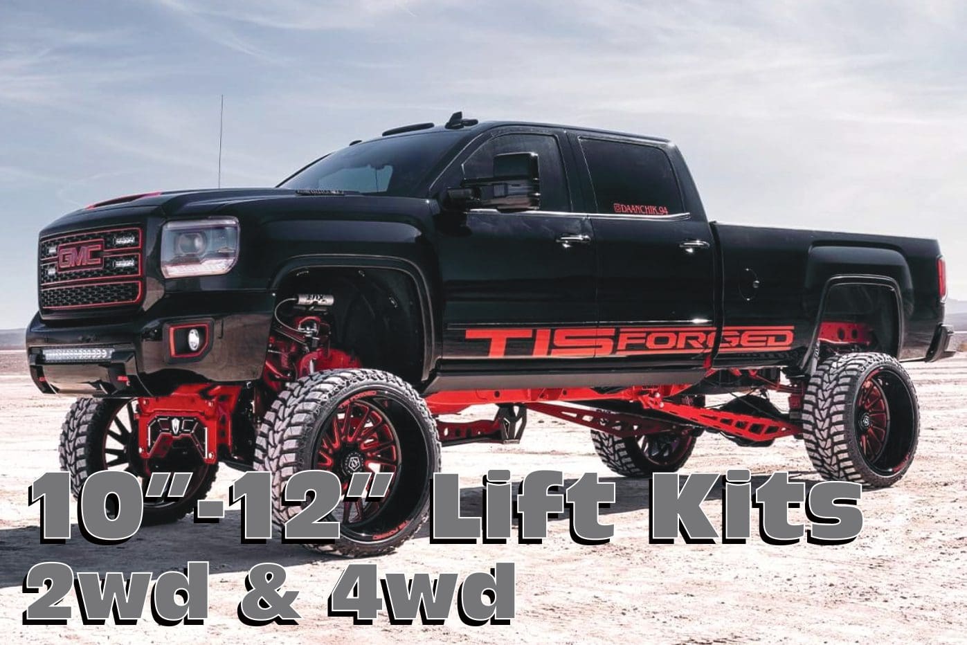 Black GMC truck with lift kit and large wheels.