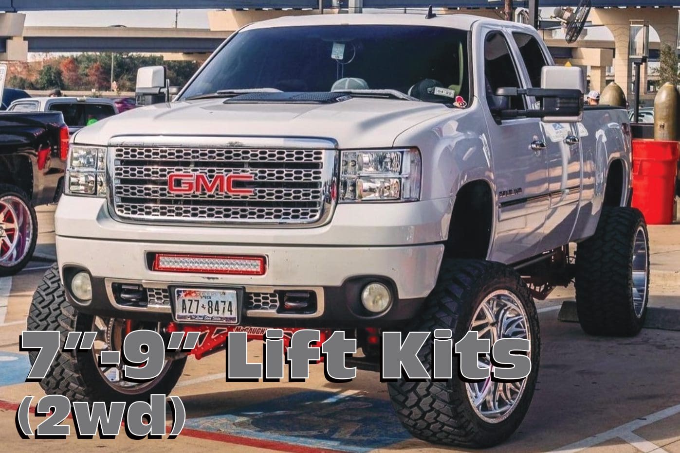 White GMC truck with lift kit.