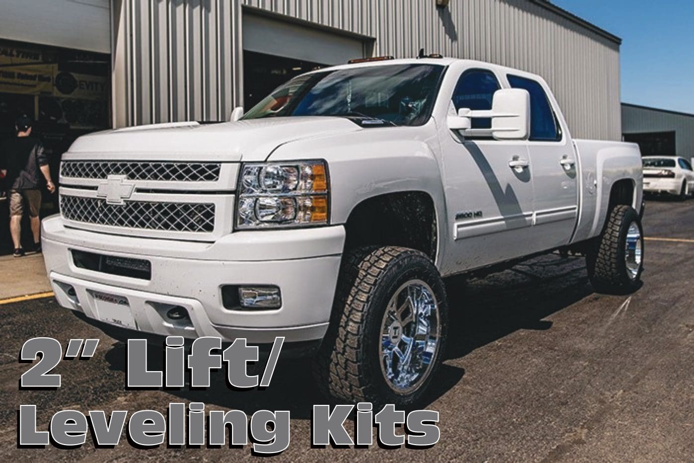 White Chevrolet Silverado pickup truck with lift kit.