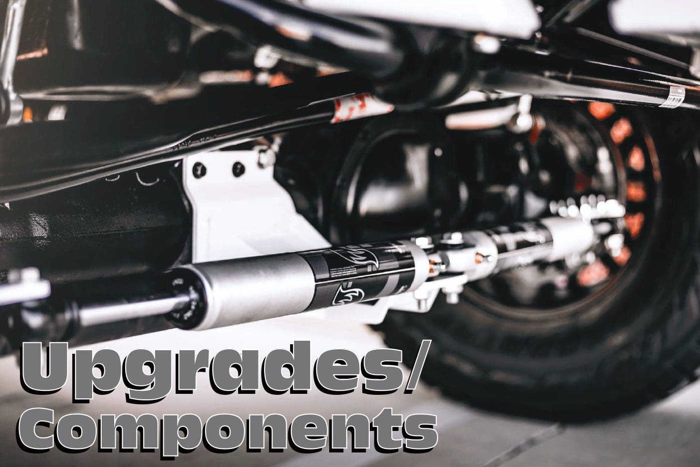 A motorcycle with the word upgrades / components written above it.