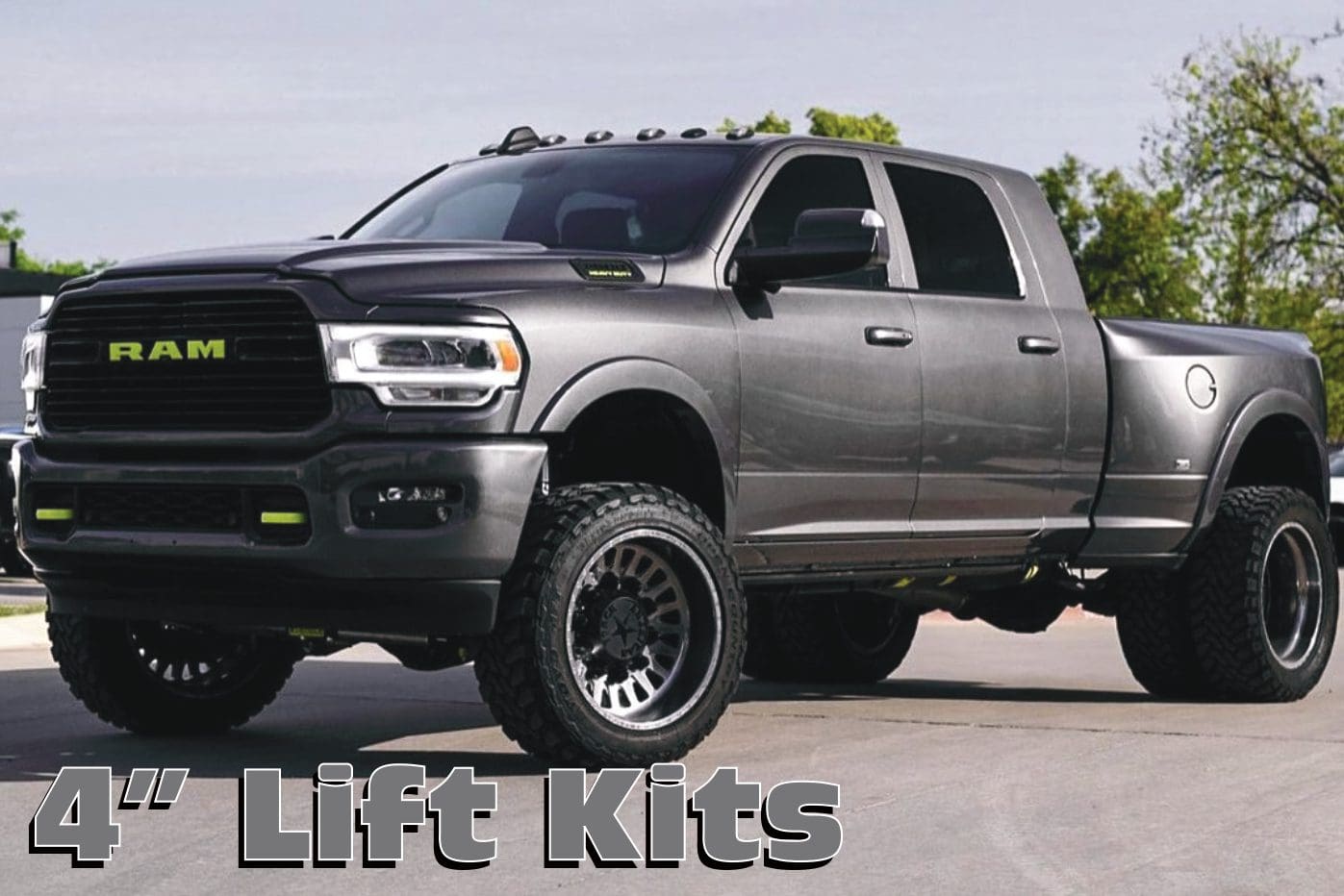 A gray truck with lift kits on it.