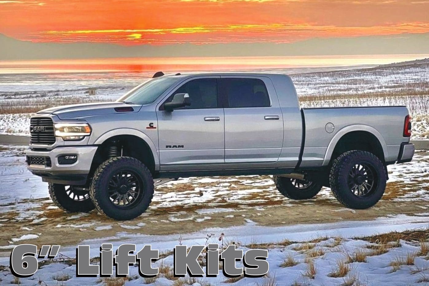 A silver truck parked on top of a beach.