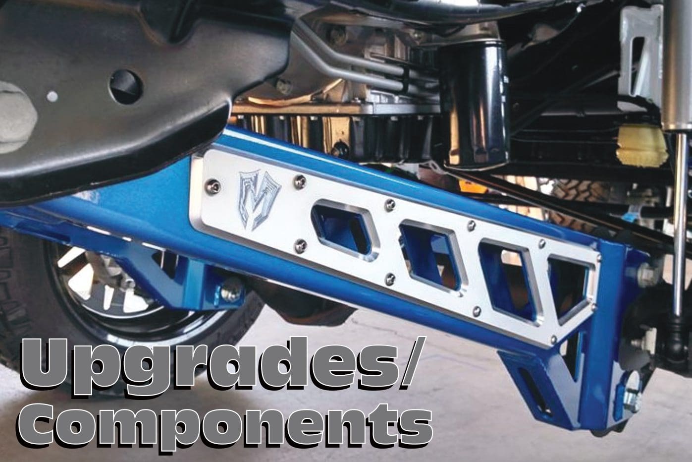 A blue motorcycle frame with the words upgrades / components written in front of it.