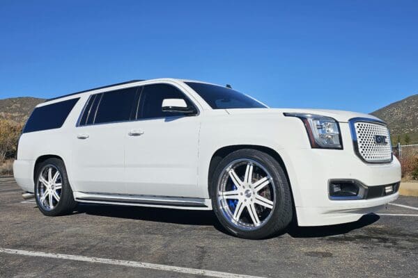 White GMC Yukon XL SUV custom rims.